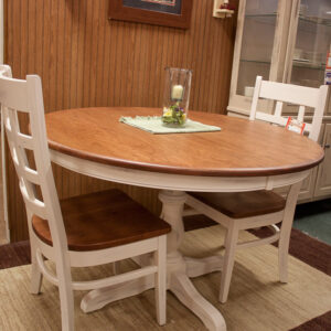 solid cherry 48 inch round dining table with painted ladder backed chairs at fireside side