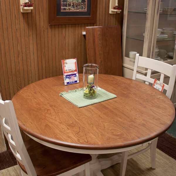 solid cherry 48 inch round dining table with painted ladder backed chairs at fireside top